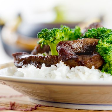 Chinese beef and broccoli on rice clipart