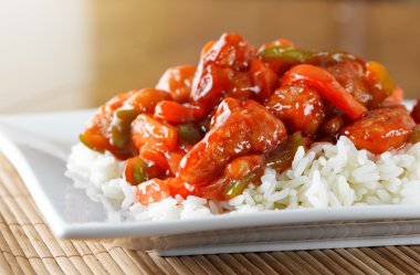 Sweet and sour pork on rice clipart