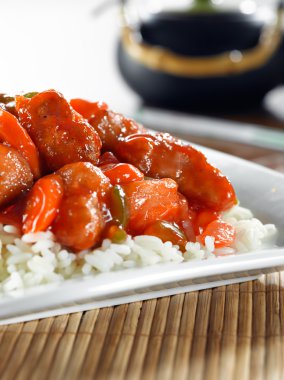 Sweet and sour pork on rice clipart