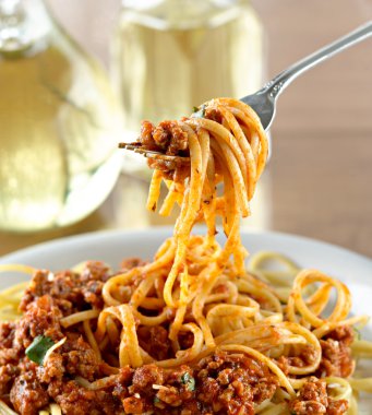 Spaghetti hanging on a fork at dinner clipart