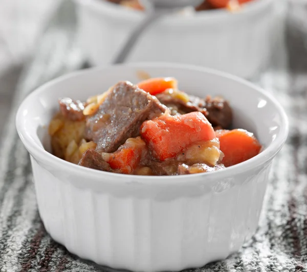 Beef stew cooling off on a kitchen towel with selective focus.