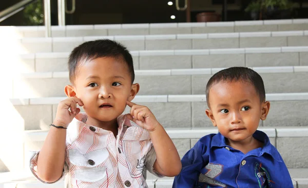 stock image Two small children who have different pose