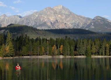 Fly Fishing In Rocky Mountains, Alberta, Canada clipart