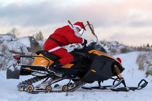 Santa Claus on snowmobile — Stock Photo, Image