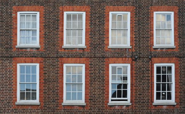 Brick wall with eight large windows in London