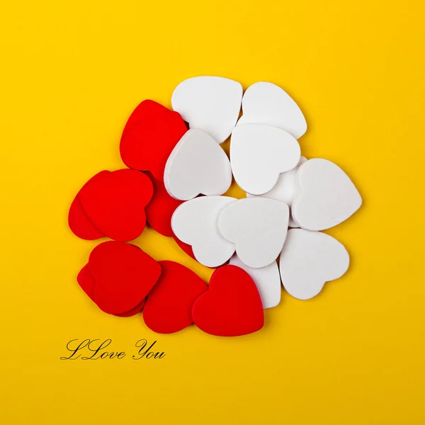 White and red hearts on yellow background — Stock Photo, Image