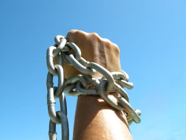 Iron chain in woman's fist — Stock Photo, Image