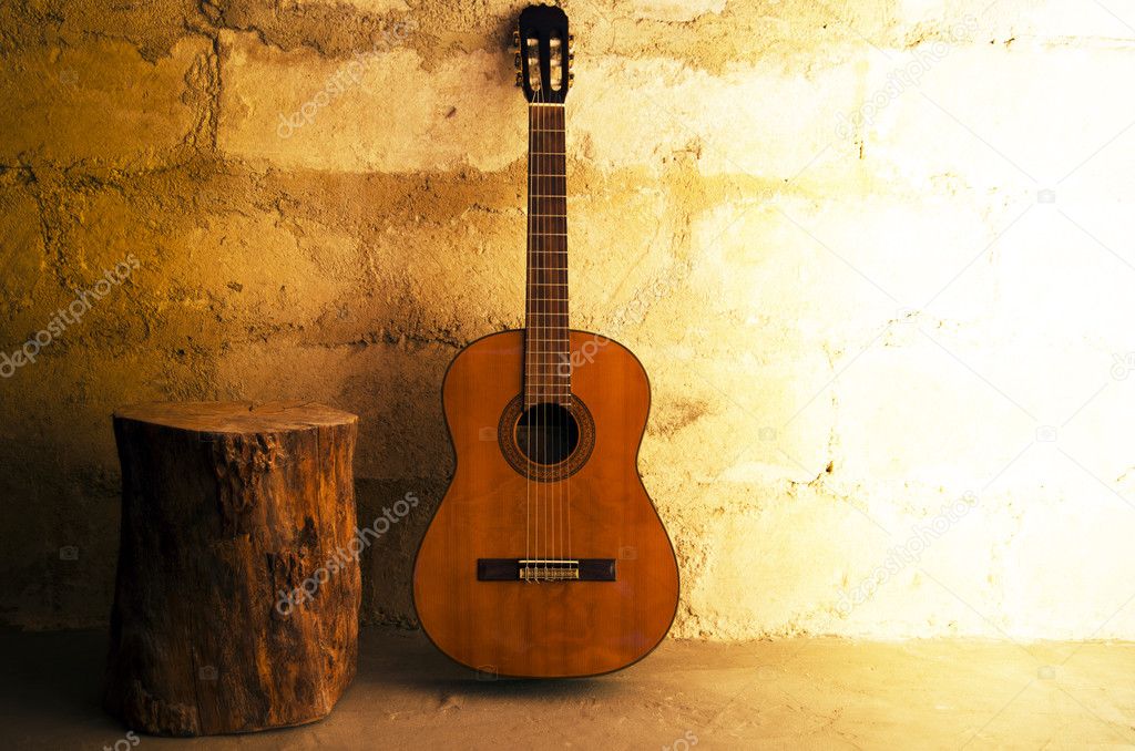 Acoustic guitar on old wall