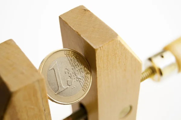 stock image Euro coin in a wooden clamp