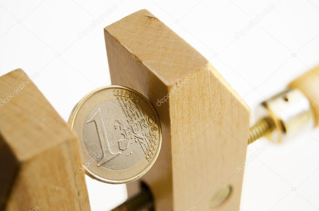 Euro coin in a wooden clamp