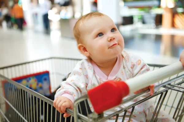 Beautiful baby girl in shopping cart - trolley — Stock Photo, Image