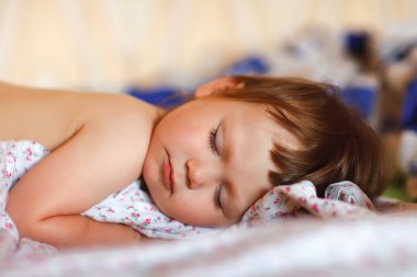 Portrait of adorable sleeping baby clipart