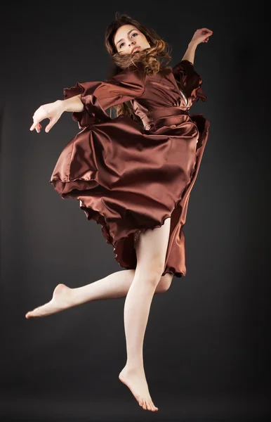Beautiful dancer jumping on dark background — Stock Photo, Image