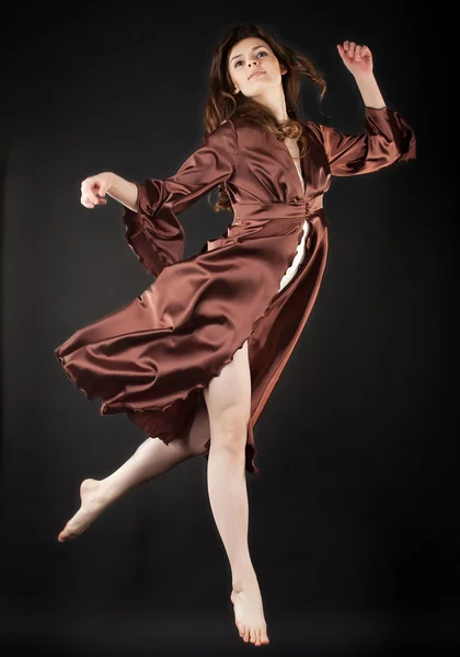 Beautiful dancer jumping on dark background — Stock Photo, Image