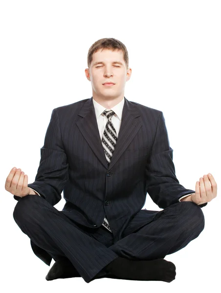 Бизнесмен медитирует, изолированный на белом фоне — стоковое фото
