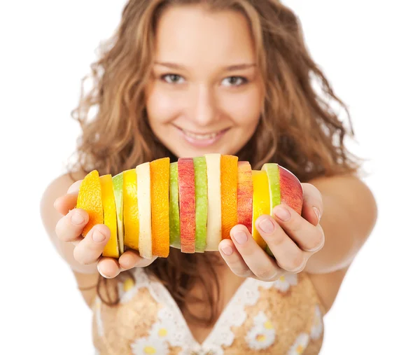 Portrait of happy young woman holding mixed fruits over white background — Stock Photo, Image
