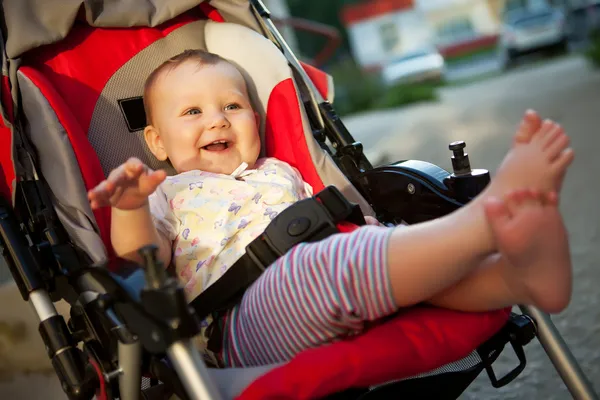 Baby in sitting stroller on nature — Stock Photo, Image