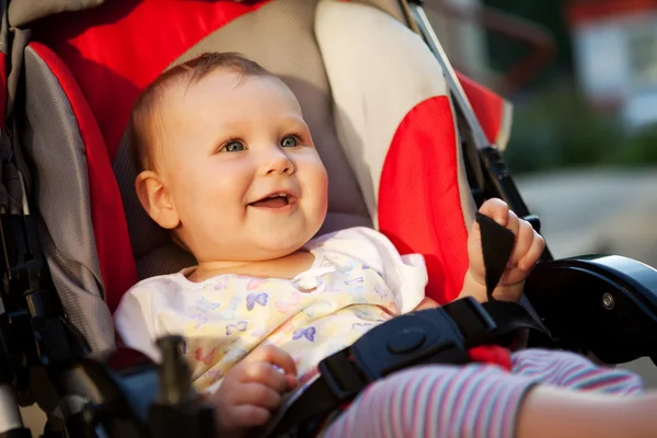 Baby in sitting stroller on nature — Stock Photo, Image