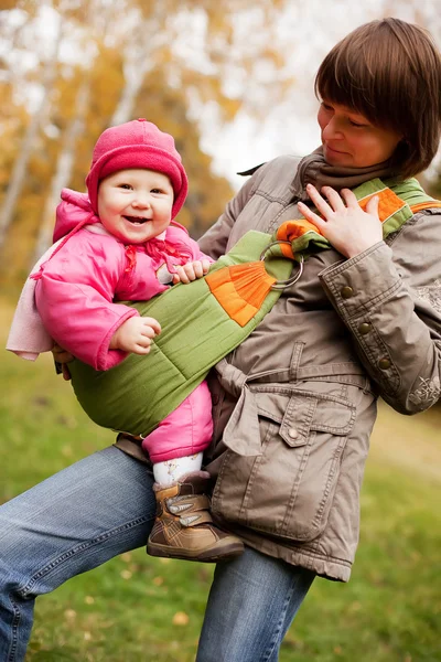 Young mother and looking at daughter outdoors — Stock Photo, Image