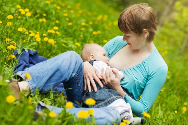 Young mother and looking at daughter outdoors — Stock Photo, Image