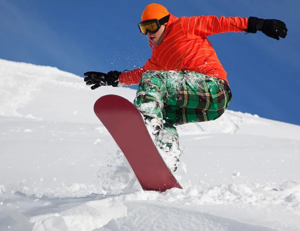 Snowboarder doing a toe side carve with deep blue sky in background — Stock Photo, Image