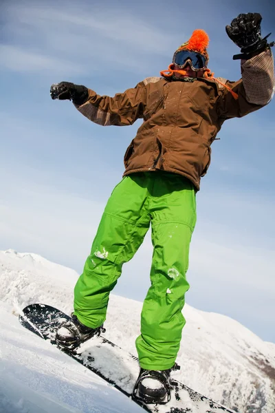 Сноубордист стрибає через повітря з глибоким блакитним небом на фоні — стокове фото