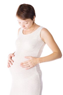 Caucasian woman who is 9 months pregnant on white background clipart