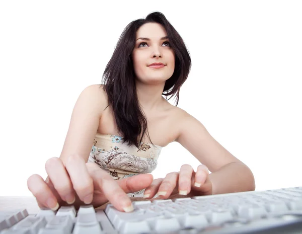 Closeup portrait of a young woman sitting on table and using a computer — Stock Photo, Image