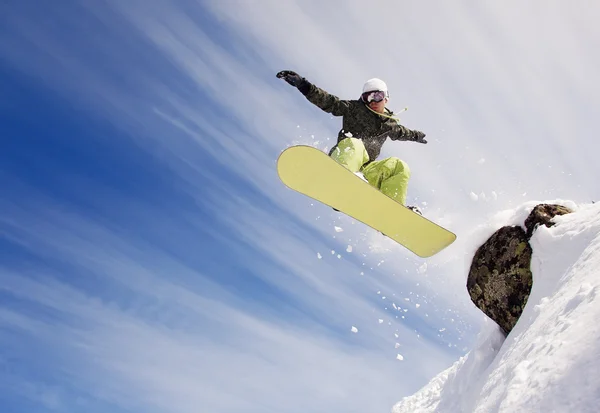 Snowboarder springen door de lucht met diep blauwe lucht op de achtergrond — Stockfoto