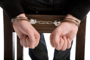 Detail of the hands of a arrested man, with handcuffs clipart