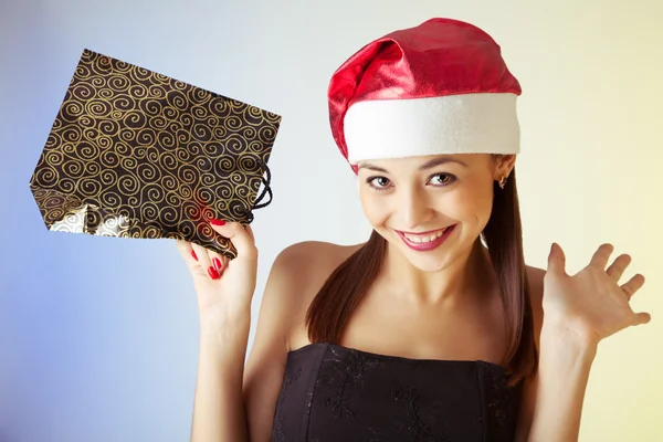 Winter portrait of a smiling woman with a gift in her hands — Stock Photo, Image
