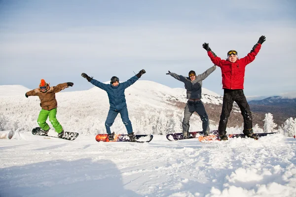 Happy snowboarding team in winter mountains — Stock Photo, Image
