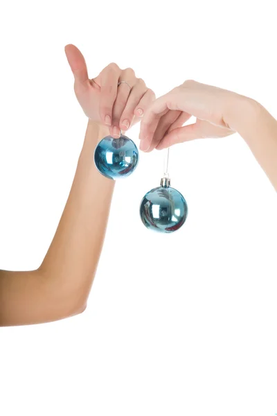 Female hands holding a blue christmas ball Stock Photo