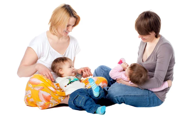 Two mothers with children on a white background — Stock Photo, Image