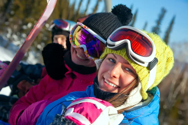 Snowboarders on the chairlift smile for the camera — Stock Photo, Image