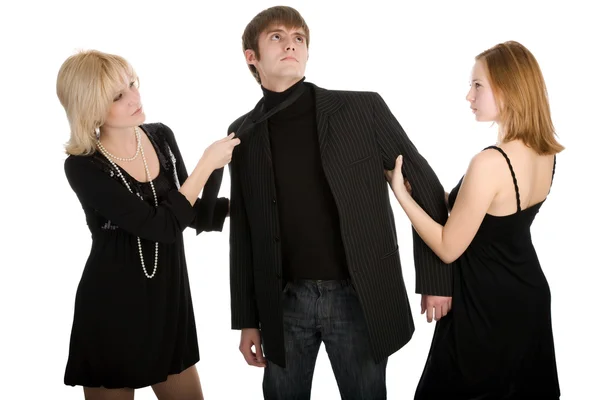 Two women pulling a man in opposite sides — Stock Photo, Image