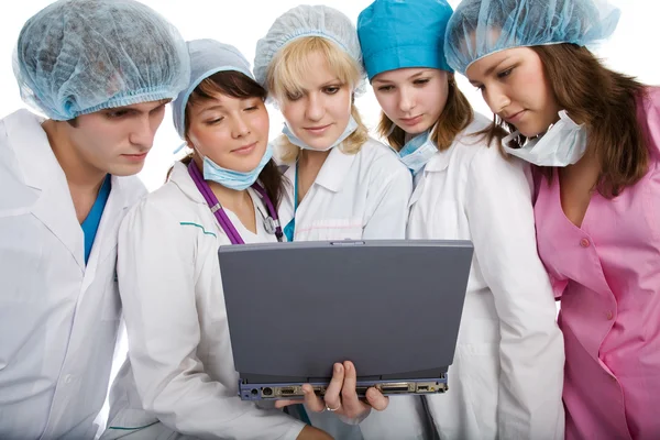 Group of young doctors with laptop — Stock Photo, Image