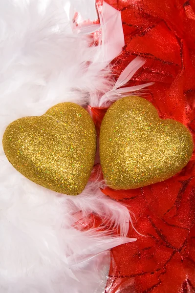 Two hearts over white and red feathers background — Stock Photo, Image