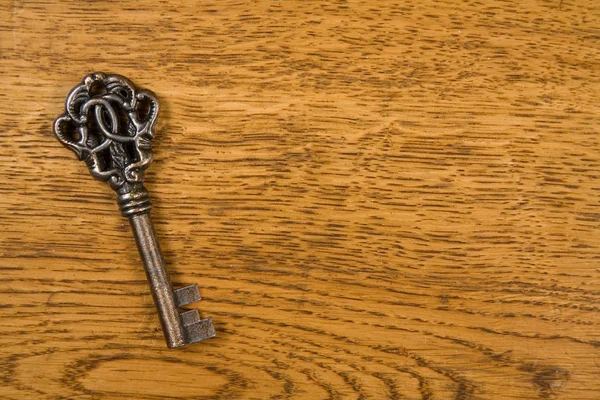 Old key over wood background — Stock Photo, Image