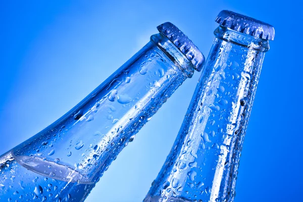 Transparent soda bottles with caps and water drops — Stock Photo, Image