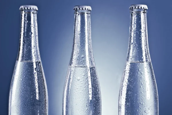 Soda bottles with caps and water drops — Stock Photo, Image