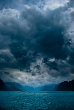 Fjord with dark clouds clipart