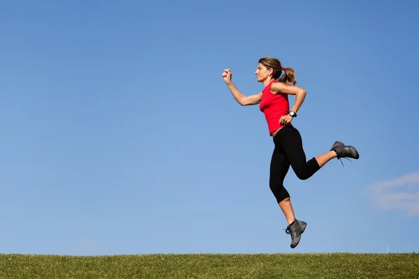 Jumping at the top of the hill — Stock Photo, Image