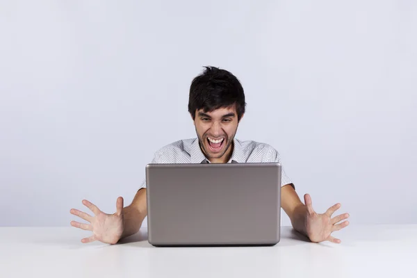 Young man shouting to a laptop Stock Photo