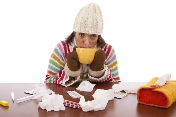 stock image Woman with flu symptoms drinking a hot drink