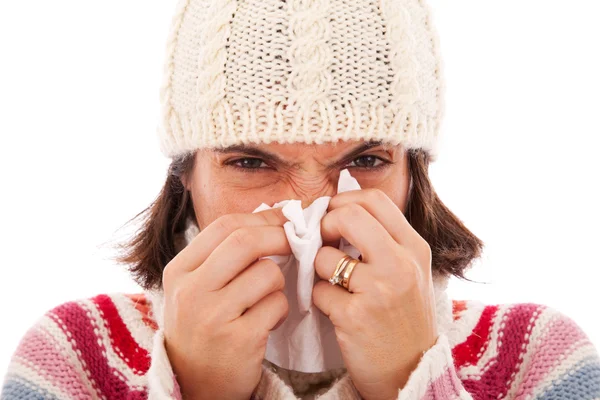 Woman sneezing to a tissue — Stock Photo, Image