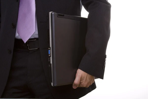 Empresário segurando um laptop — Fotografia de Stock