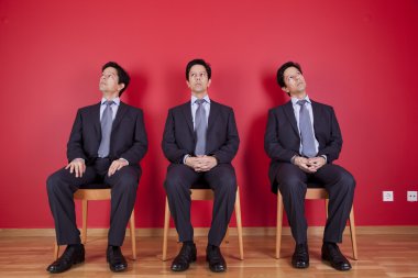 Three twin businessman waiting clipart