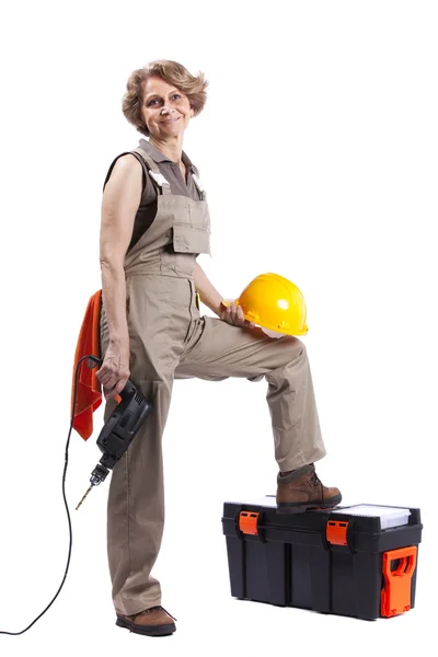Senior woman with a drill tool — Stock Photo, Image