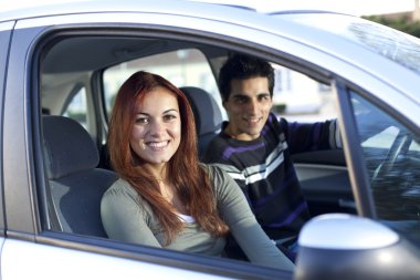 Young couple inside the car clipart